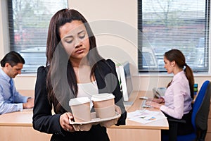 Fed Up Female Intern Fetching Coffee In Office