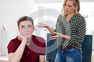 Fed Up Teenage Boy Being Nagged By Mother At Home