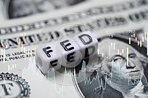 FED wording with stock market chart on USD dollar banknote for Federal reserve increase and decrease interest rate control which