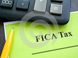 Federal Insurance Contributions Act FICA tax papers and calculator.