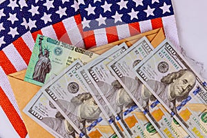 Federal monetary assistance stimulus U.S. economic tax return check USA dollar cash banknote on American flag Global pandemic