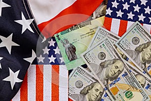 Federal monetary assistance stimulus U.S. economic tax return check USA dollar cash banknote on American flag Global pandemic