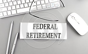 FEDERAL RETIREMENT text on paper with keyboard on grey background