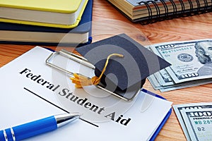 Federal student aid and small Square academic cap.