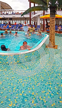 Federation of Saint Kitts and Nevis - May 13, 2016: The people resting at pool on Carnival Cruise Ship Fascination