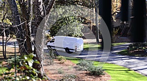 A Fedex, Ups or Usps Delivery Truck Making a Delivery