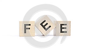 FEE - text from wooden blocks with letters, top view on white background