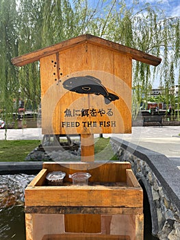 Feed the fish with wooden sign