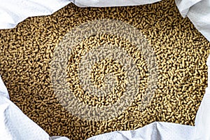 Feed for livestock. Rich nutritional Pellet animal feed on white background. A bag. Large granules crumbled.