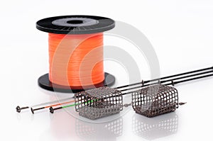 Feeder baskets next to feeder rod tips and orange monofilament f