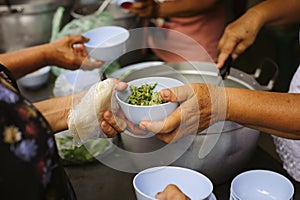 Feeding the poor to hands of a beggar : Concept of famine and social inequality : feeding food for beggar poverty concept : The