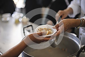 Feeding the poor to hands of a beggar. Poverty concept