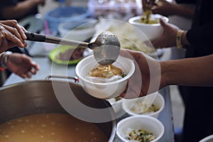 Feeding the poor to hands of a beggar. Poverty concept photo