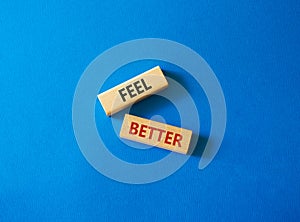 Feel better symbol. Wooden blocks with words Feel better. Beautiful blue background. Business and Feel better concept. Copy space