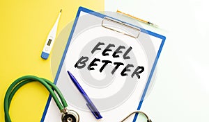 FEEL BETTER text on a letterhead in a medical folder on a beautiful background