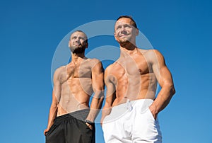 Feel confidence. Men muscular body posing confidently. Guys muscular belly posing. Sport and bodycare. Muscular