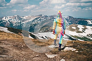 Feel freedom concept in mountains, woman traveling in a unicorn