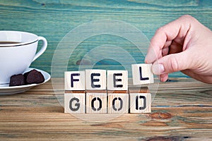 Feel good. Wooden letters on the office desk, informative and communication background