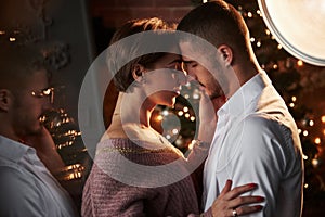 Feel the moment. Closeness of the guy and girl in luxury wear that dancing and flirting. Gorgeous reflection from the side