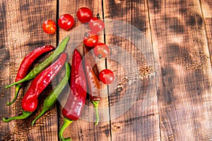 Feel the piquancy. Chili peppers and cherry tomatoes. Red and green vegetables. Organic vegetables