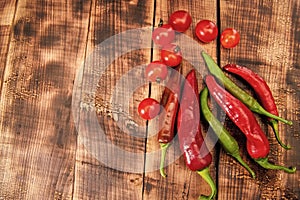 Feel the piquancy. Chili peppers and cherry tomatoes. Red and green vegetables. Organic vegetables photo