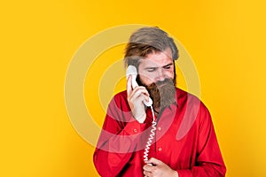 Feel sad about conversation. mature hipster with beard with retro phone. brutal caucasian guy speak on telephone