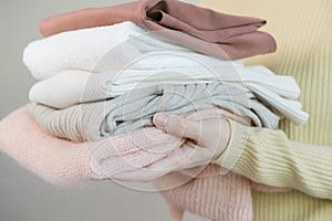 Feel softness, asian young woman, girl hand in holding pile, stack folding clean clothes after washing, laundry and dry. Household