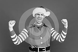 feel the success. happy shouting man in elf costume. xmas guy in santa claus hat