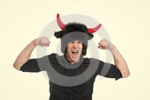 Feeling so angry. Man shouting face wears hat of devil with horns. Guy black shirt angry aggressive demonstrate strength