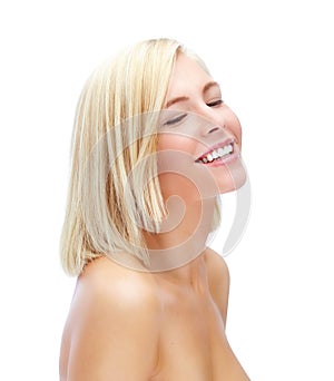 Feeling carefree and beautiful. Gorgeous blonde woman with eyes closed while isolated on white.