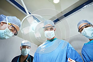 Feeling confident about the surgery. Low angle shot of surgeons in an operating room.