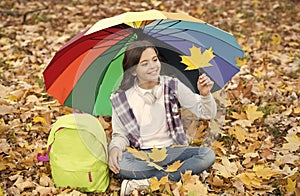 Feeling dry. autumn kid under colorful umbrella. feel the inspiration. happy childhood. back to school. girl with