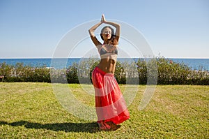 Feeling flirty. Sensual girl on sea beach. Eastern beauty. woman with fit belly. Spa and relax. Perfect body of belly dancer