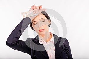 Feeling headache. Frustrated young woman holding headache tablets