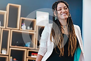 Feeling positive about my new business. Low angle portrait of an attractive young woman standing in her home office.