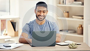 Feeling productive today. a young businessman using a laptop in an office at work.