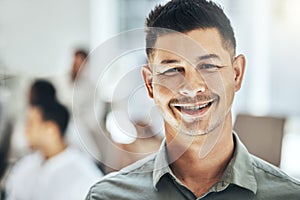 Feeling ready and equipped. a businessman smiling at a business meeting in a modern office.