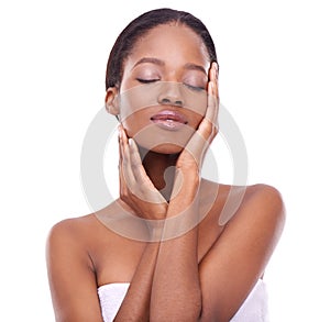 Feeling the results of a great skincare program. Studio shot of a beautiful young woman touching her skin.