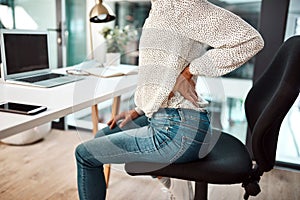 Feeling the tension flow straight to her back. Closeup shot of an unrecognisable businesswoman experiencing back pain