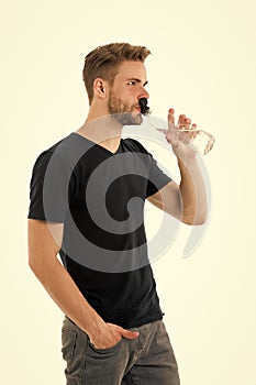 Feeling thirsty. Man athlete hold water bottle. Guy drink water on white background. Man care health and water balance