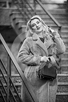 Feeling warm and protected. european winter. girl warm coat stairs background. faux fur coat fashion. stylish business
