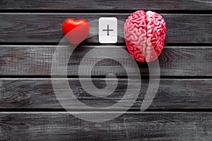 Feelings and mind concept with brain plus heart on wooden background top view mock up