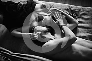 Feelings. Young beautiful couple lying on the couch. top view
