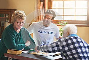 It feels good to do good. a volunteer working with seniors at a retirement home.