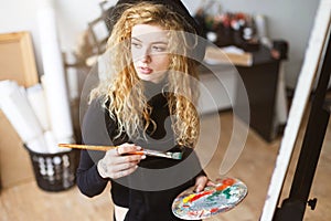 Feemale Artist Sitting with Brush and Palette