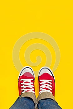 Feet From Above, Teenager in Sneakers Standing on Yellow Backgro