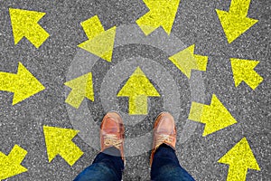 Feet and arrows on road background. Taking decisions for the future with many arrows choices, left right or move forward. Hipster