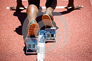 Feet of an athlete on a starting block about to run