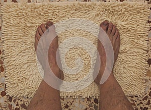 Feet on a bath mat