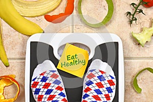 Feet on bathroom scale with Eat Healthy